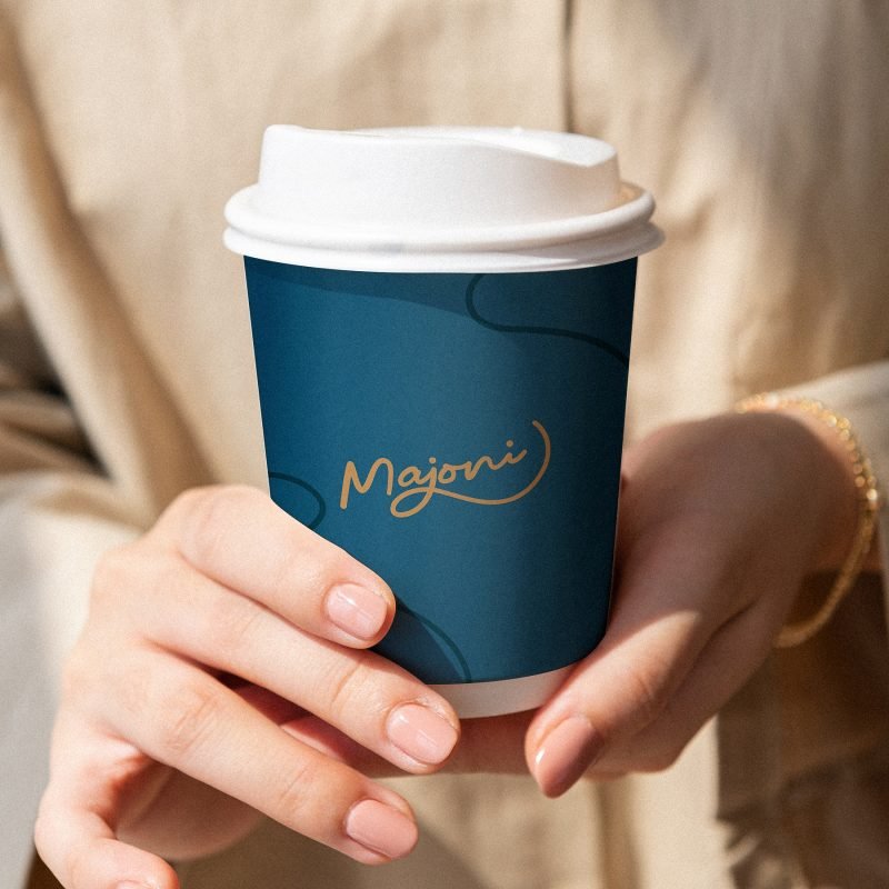 Woman holding a coffee cup mockup